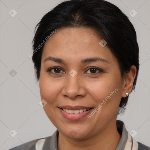Joyful latino young-adult female with medium  brown hair and brown eyes