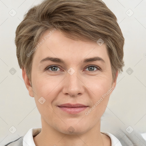 Joyful white young-adult female with short  brown hair and grey eyes