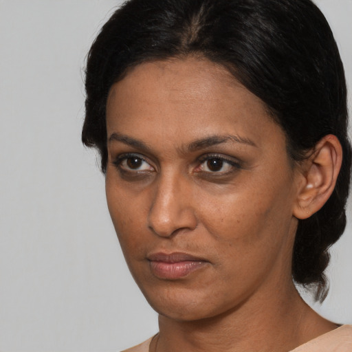 Neutral black young-adult female with medium  brown hair and brown eyes