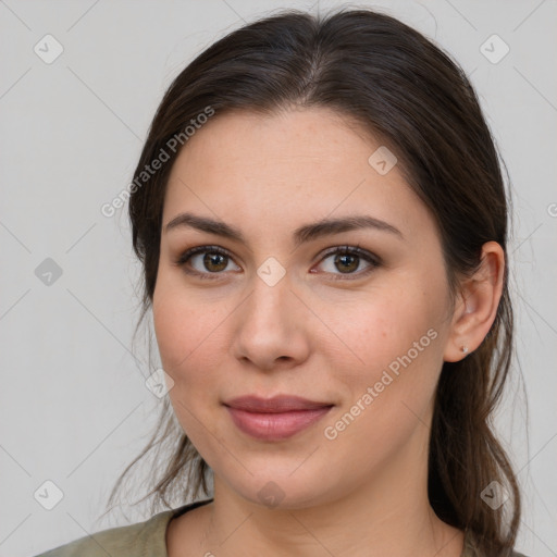 Joyful white young-adult female with long  brown hair and brown eyes