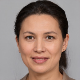 Joyful white adult female with medium  brown hair and brown eyes