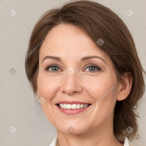 Joyful white young-adult female with medium  brown hair and grey eyes