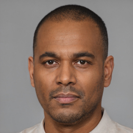 Neutral latino adult male with short  black hair and brown eyes