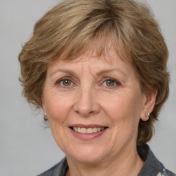 Joyful white middle-aged female with medium  brown hair and grey eyes