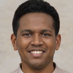 Joyful latino young-adult male with short  black hair and brown eyes