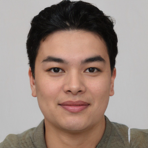 Joyful asian young-adult male with short  black hair and brown eyes