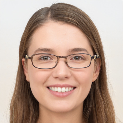 Joyful white young-adult female with long  brown hair and blue eyes