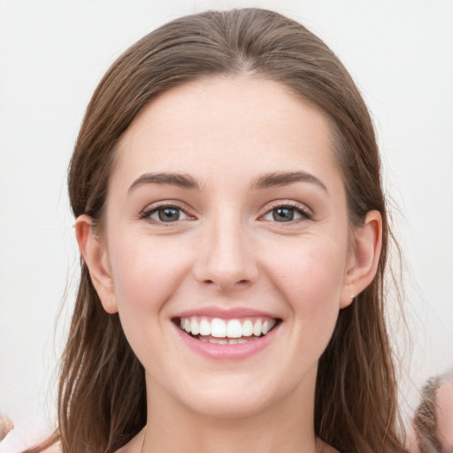 Joyful white young-adult female with long  brown hair and grey eyes