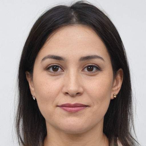 Joyful latino young-adult female with long  brown hair and brown eyes