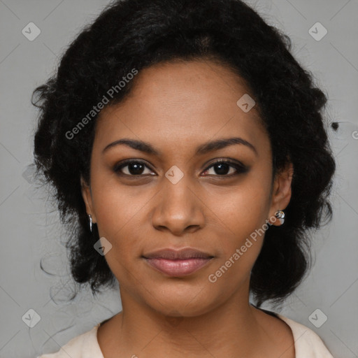 Joyful black young-adult female with long  black hair and brown eyes