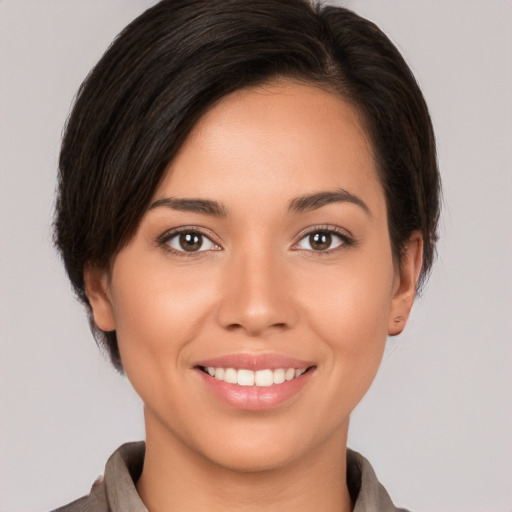 Joyful white young-adult female with medium  brown hair and brown eyes