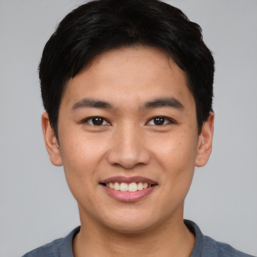 Joyful asian young-adult male with short  black hair and brown eyes