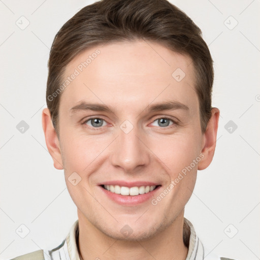 Joyful white young-adult male with short  brown hair and grey eyes