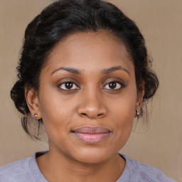 Joyful black young-adult female with medium  brown hair and brown eyes