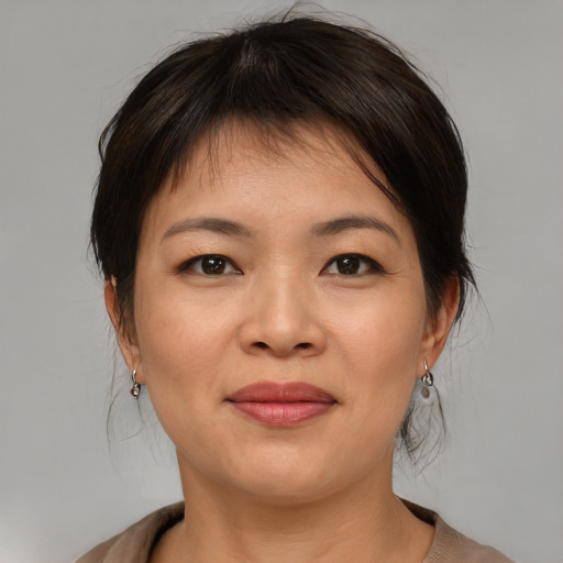 Joyful asian young-adult female with medium  brown hair and brown eyes