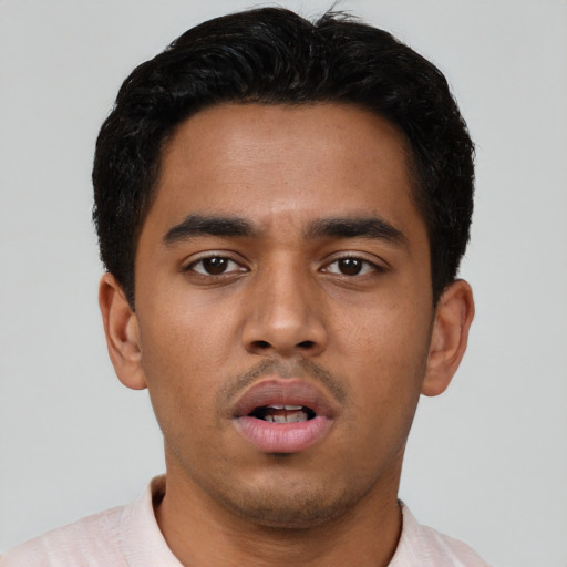Neutral latino young-adult male with short  black hair and brown eyes