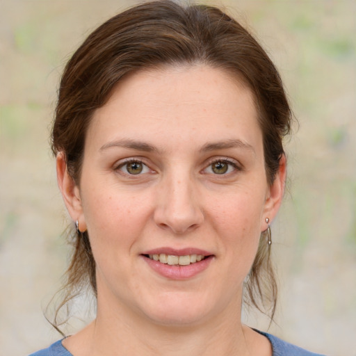 Joyful white young-adult female with medium  brown hair and green eyes