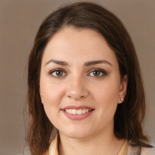 Joyful white young-adult female with medium  brown hair and brown eyes