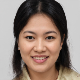 Joyful asian young-adult female with medium  brown hair and brown eyes