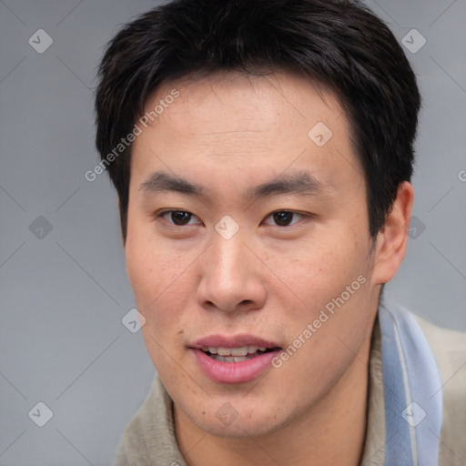 Joyful asian young-adult male with short  brown hair and brown eyes