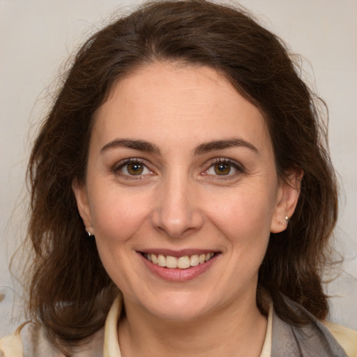 Joyful white young-adult female with medium  brown hair and brown eyes