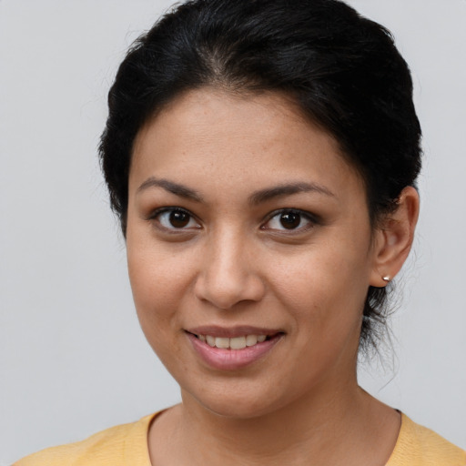 Joyful latino young-adult female with short  brown hair and brown eyes
