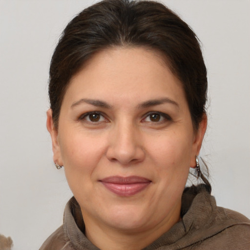 Joyful white adult female with short  brown hair and brown eyes