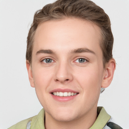 Joyful white young-adult male with short  brown hair and grey eyes