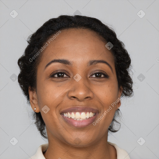 Joyful black young-adult female with long  black hair and brown eyes