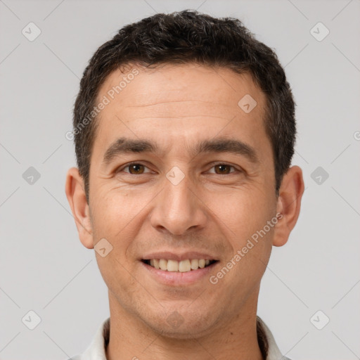 Joyful white adult male with short  brown hair and brown eyes