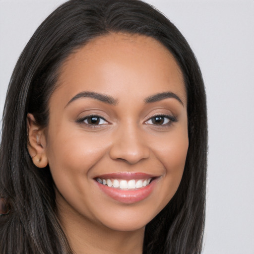 Joyful latino young-adult female with long  black hair and brown eyes