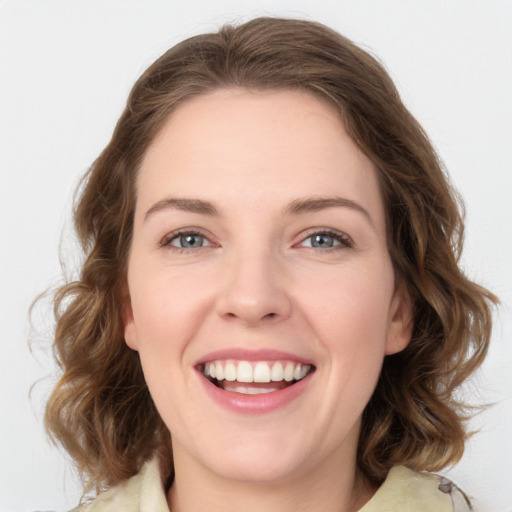 Joyful white young-adult female with medium  brown hair and green eyes