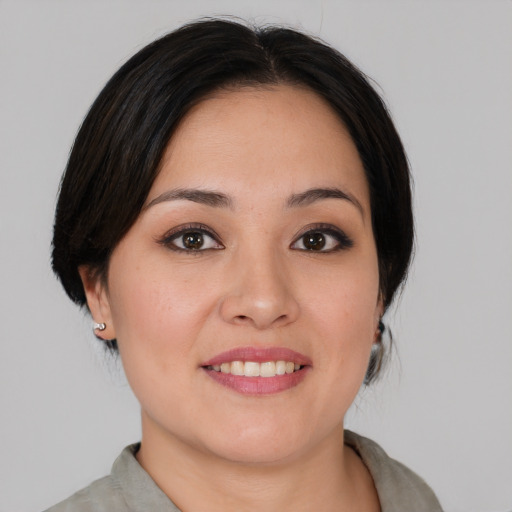 Joyful asian young-adult female with medium  black hair and brown eyes