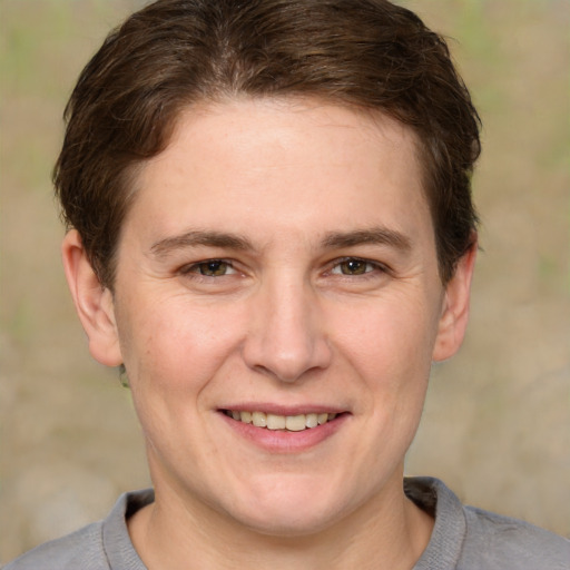 Joyful white adult female with short  brown hair and grey eyes