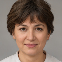 Joyful white adult female with medium  brown hair and brown eyes