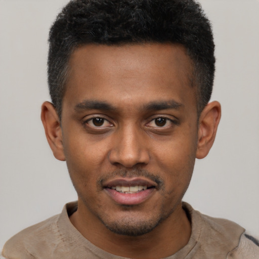 Joyful latino young-adult male with short  black hair and brown eyes
