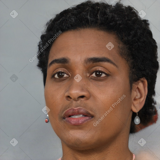 Joyful black young-adult female with short  brown hair and brown eyes