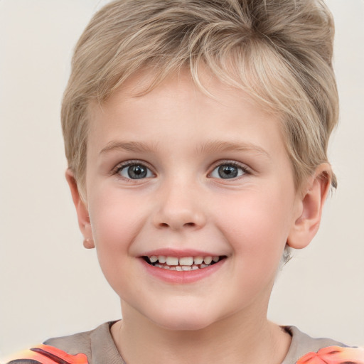 Joyful white child male with short  blond hair and grey eyes