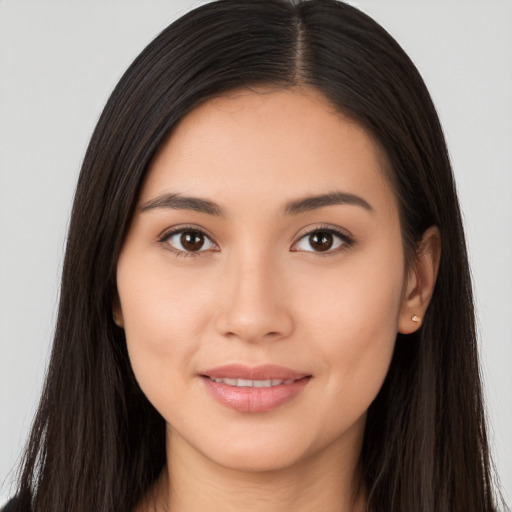 Joyful latino young-adult female with long  brown hair and brown eyes