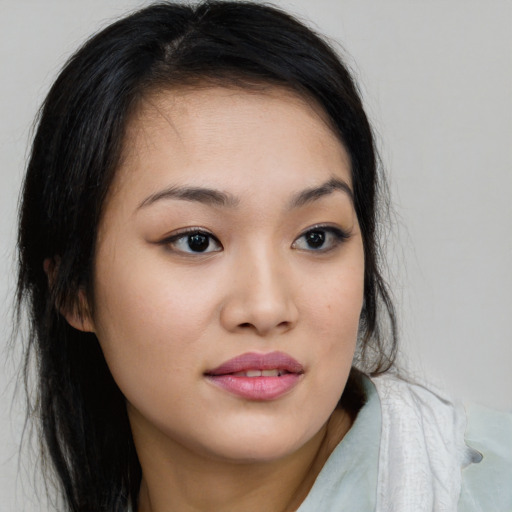 Joyful asian young-adult female with long  brown hair and brown eyes