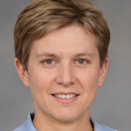 Joyful white adult male with short  brown hair and grey eyes