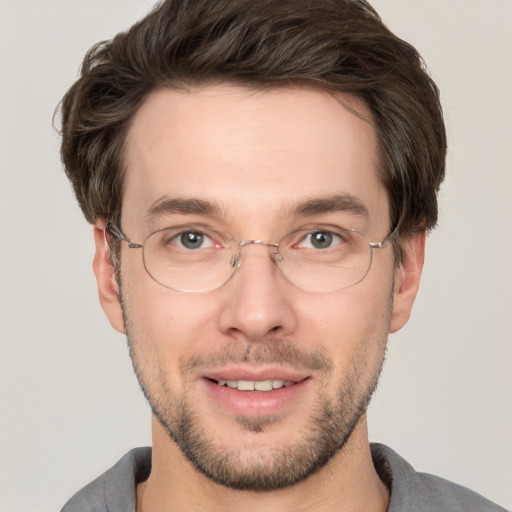 Joyful white adult male with short  brown hair and brown eyes