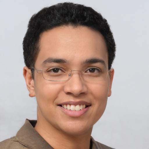 Joyful latino young-adult male with short  brown hair and brown eyes