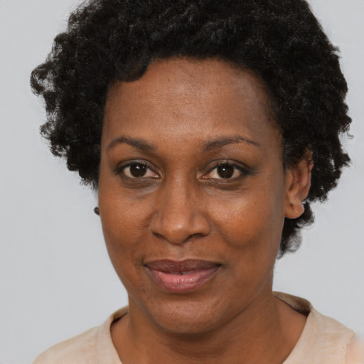 Joyful black adult female with short  black hair and brown eyes