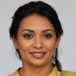 Joyful latino young-adult female with medium  brown hair and brown eyes