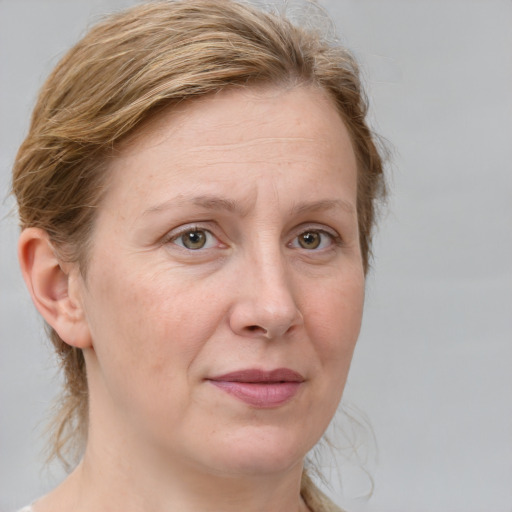 Joyful white adult female with medium  brown hair and blue eyes