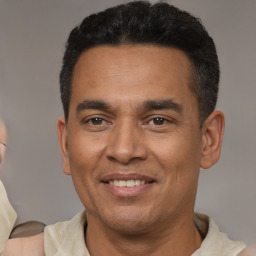 Joyful latino adult male with short  brown hair and brown eyes