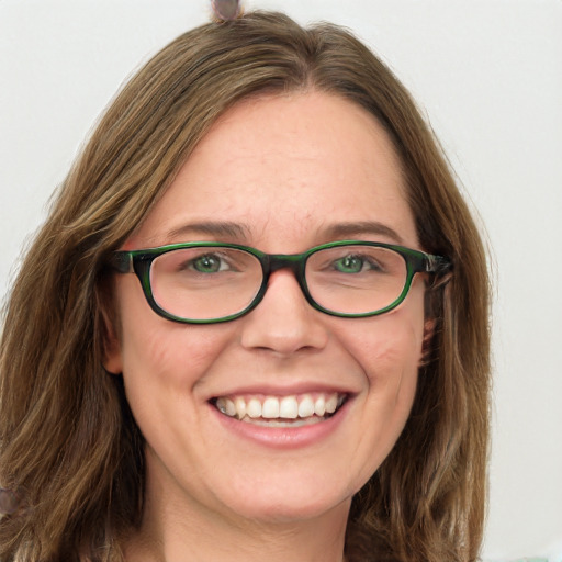 Joyful white adult female with long  brown hair and green eyes