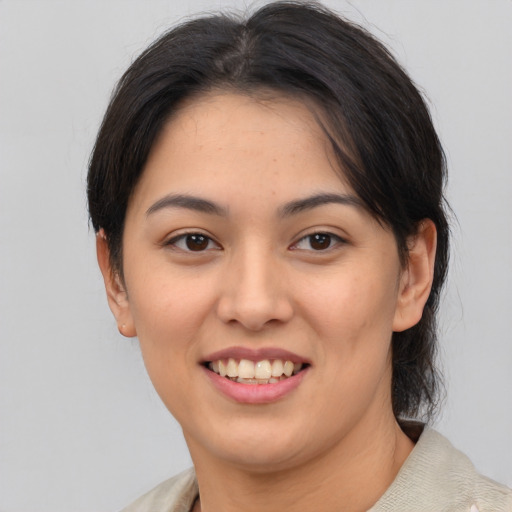 Joyful latino young-adult female with medium  brown hair and brown eyes