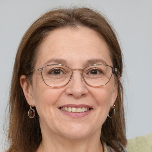 Joyful white middle-aged female with medium  brown hair and grey eyes